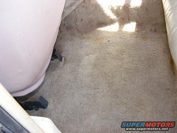 Carpeted floor and seat base inside a vehicle