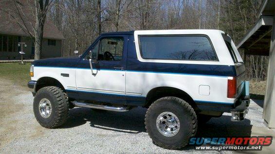 1994 Ford Bronco, two-tone blue and white, lifted with aftermarket wheels