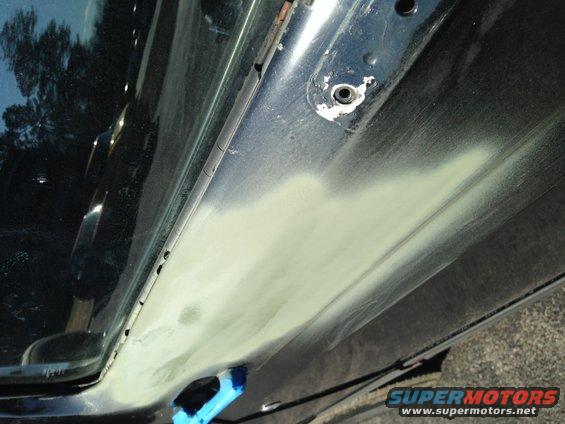 close-up of car door panel with body filler applied