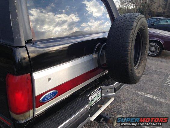 Black Ford Bronco rear with spare tire and chrome bumper. License plate M94-73V