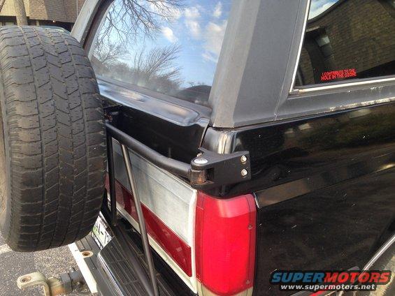 1990 Ford Bronco rear with external spare tire mount and red "I CONTRIBUTE TO THE HOLE IN THE OZONE" sticker