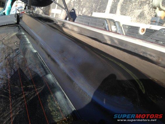 Black rear window trim on a vehicle with defroster lines visible