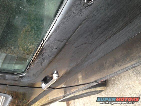 Close-up of a vehicle's interior door panel, showing the window frame and door handle