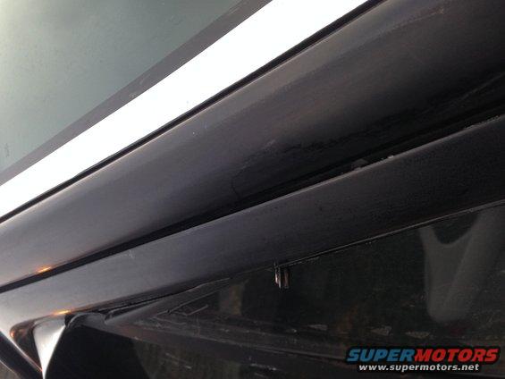 close-up of black trim and white stripe on a vehicle window