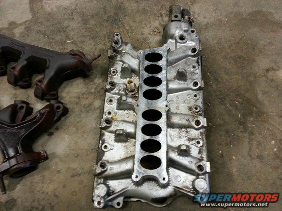 Engine intake manifold and exhaust manifolds on concrete