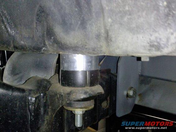 Suspension lift spacer on vehicle frame with bolt