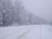 1987 Ford Bronco - A winter scene shows a snow-covered road winding through trees frosted with ice.