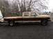 1988 Ford F-350 - This two-tone pickup truck, likely from the late 1980s, is seen from the side while towing a trailer.