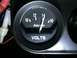 1964 Ford Ranchero - Close-up of a black Auto Meter Products voltmeter gauge, showing the needle at 14 volts.