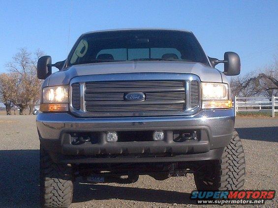Front view of a silver Ford F-Series truck with a chrome grille
