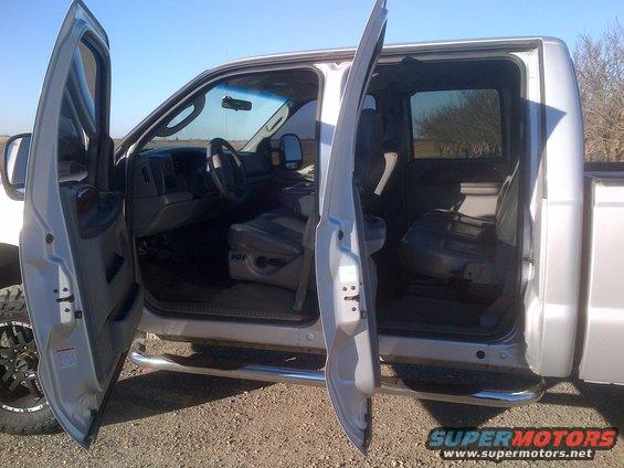 Silver pickup truck interior with front and rear doors open
