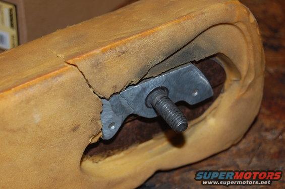 Cracked tan armrest foam with exposed metal bracket and bolt