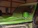 1992 Ford Bronco - A green off-road vehicle is parked inside a garage with a roll cage and a snorkel intake visible.