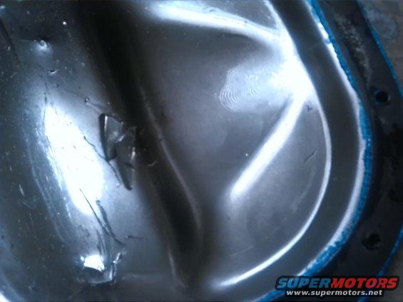 Close-up of a metal differential cover with some damage