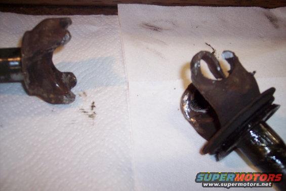 Two rusty metal knuckle joint components on a white paper towel