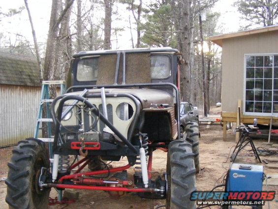 Modified off-road vehicle with large tires and roll cage