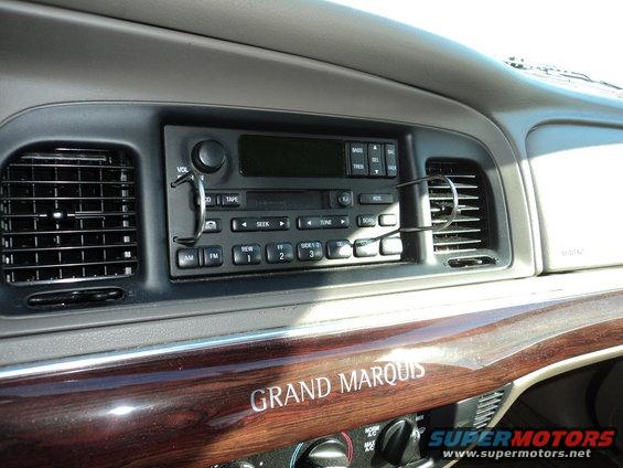 Dashboard of a 2004 Mercury Grand Marquis showing the radio and wood trim