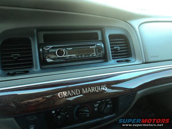 Dashboard of a 2004 Mercury Grand Marquis with a Sony stereo and wood trim