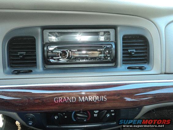 Interior shot of a Grand Marquis with aftermarket stereo and wood trim