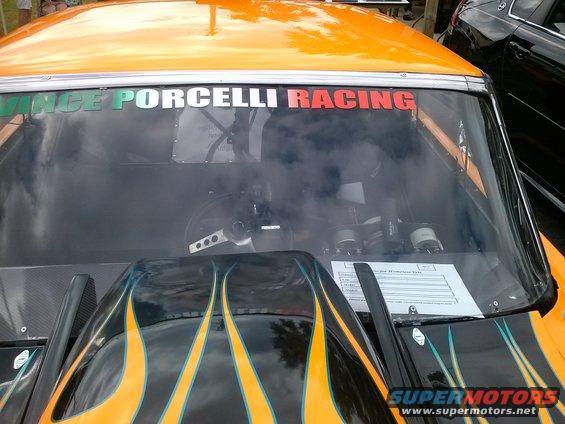 Race car interior with flames on hood and "Porcelli Racing" windshield banner