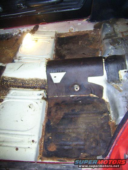 1968 Ford Mustang interior floor with significant rust and missing insulation