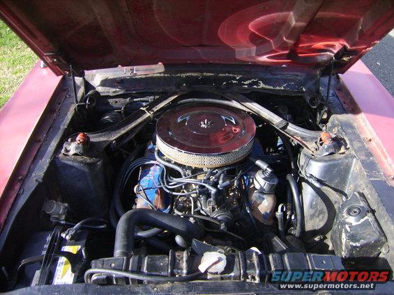 1968 Ford Mustang engine bay with V8 engine, air cleaner, and battery