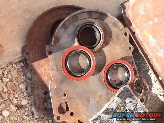 Engine crankshaft seal housing with three red-lipped seals installed