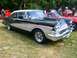 1964 Mercury Monterey - A classic two-tone 1957 Ford Fairlane 500 is displayed outdoors with other vehicles.