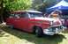 1964 Mercury Monterey - This red station wagon, likely a 1955 model, features a distinctive chrome grille and bumper.