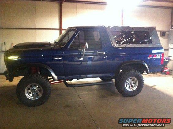 Blue lifted 1982 Ford Bronco with soft top and "FX4 OFF ROAD" decal