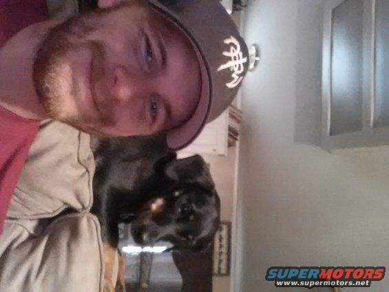 Man and dog on a couch indoors