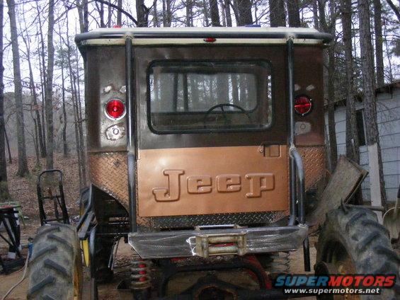 Jeep tailgate with raised lettering, diamond plate accents, and a winch bumper