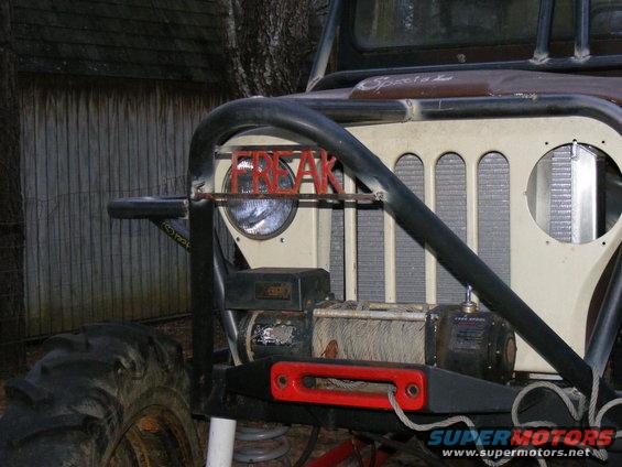 Modified Jeep CJ front end with "FREAK" letters on grille, winch, and large tires