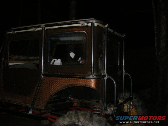 Custom SUV body with diamond plate fenders and roll cage