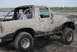 1980 Ford Bronco - This 1980 Ford Bronco is covered in mud, seen from its right side with a driver behind the wheel.