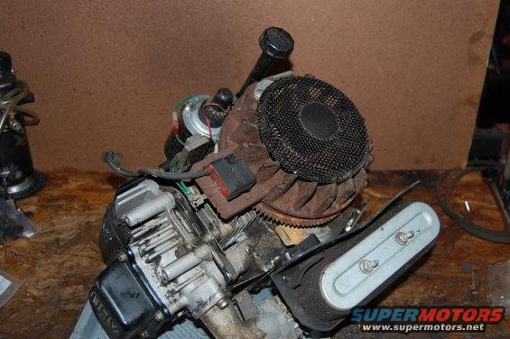 Close-up of a small engine with a black mesh fan cover