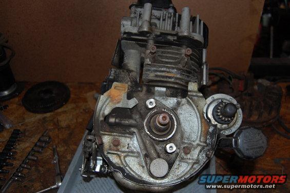 Engine with cooling fins, metal casing, and visible gears