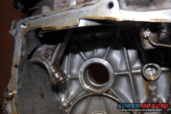 Engine part with oil residue and a metal lever