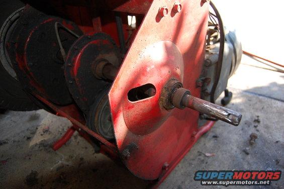 Red metal housing with a splined shaft protruding from a bearing