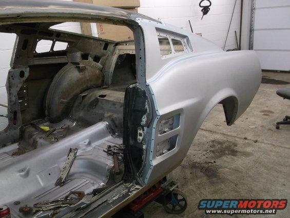 Silver 1967 Ford Mustang body, side view, undergoing restoration