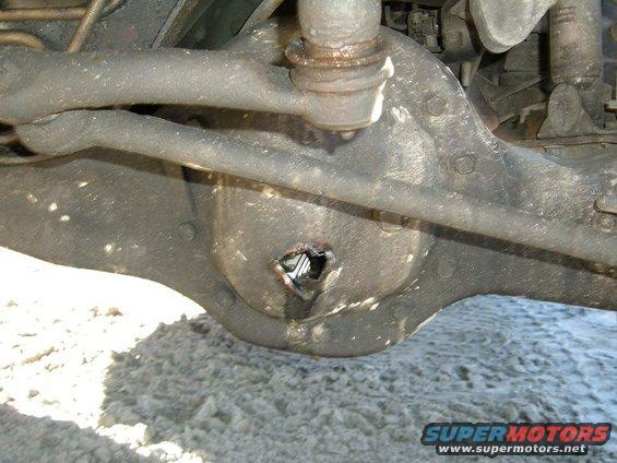 Rear axle differential housing with a hole and visible internal components