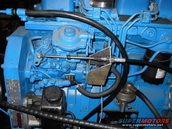 Close-up of a blue engine with various hoses and mechanical components