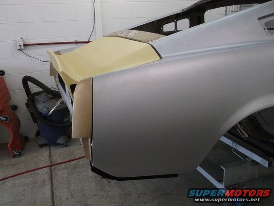 Unfinished car body, silver, rear quarter panel and trunk area, yellow primer on spoiler