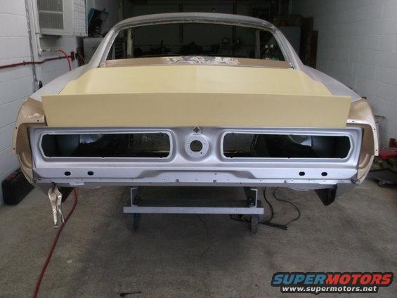 1967 Ford Mustang rear body shell undergoing restoration, with primer on the trunk lid