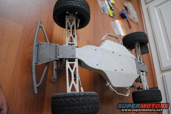 Remote control car chassis with suspension and tires, viewed from above