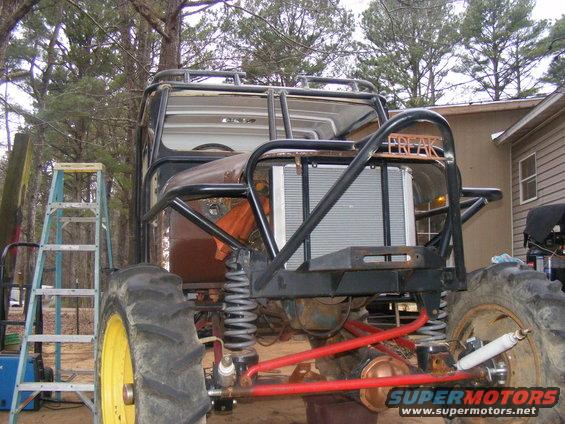 Custom off-road vehicle rear view with large tires and 'FREAK' text on roll cage