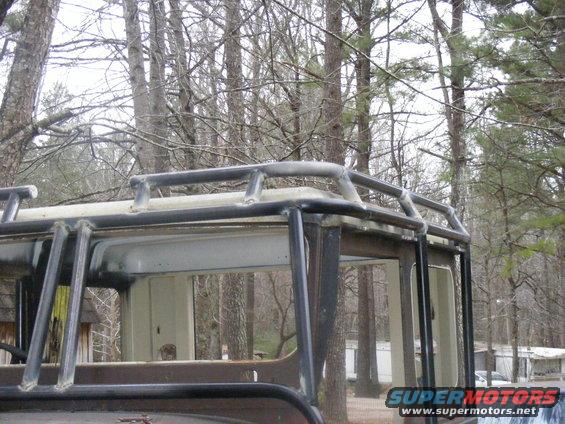 Close-up of a custom metal roll cage attached to the roof of a vehicle