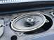 1964 Ford Ranchero - Close-up of a car speaker, likely in a dashboard, showing its condition.