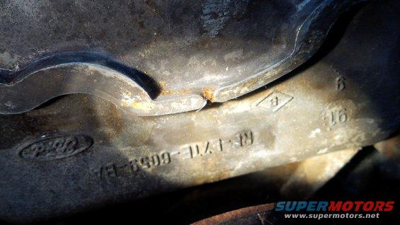 Ford part casting with "RE7L-6059-BA" and "91" stamped on it