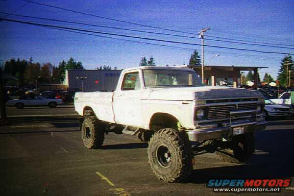 1976 Ford F-150 pickup truck with large off-road tires and suspension lift